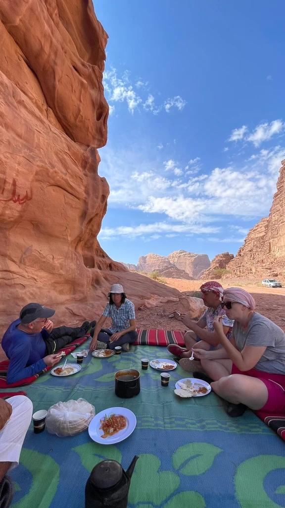 Lunch by the rock with our guests in the desert