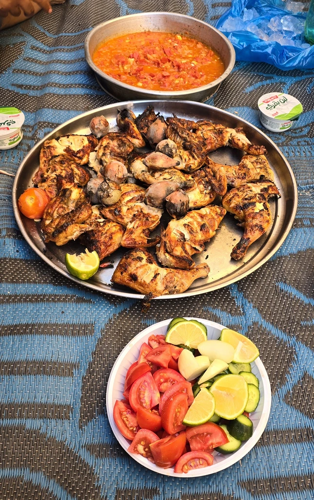 Grilled meat served with tomato and cucumber salad