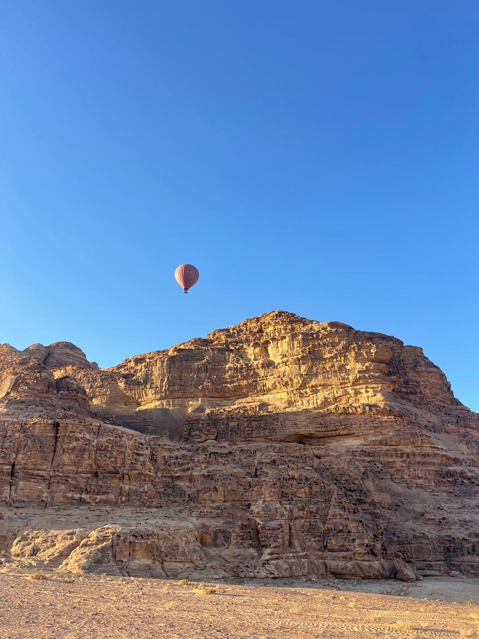 Floating Hot Air Balloon above a rock Wadi Rum, Jordan
