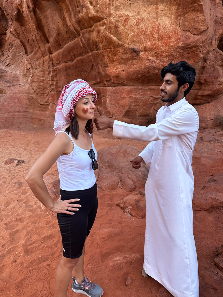 Guest wearing a traditional scarf beside a local guide