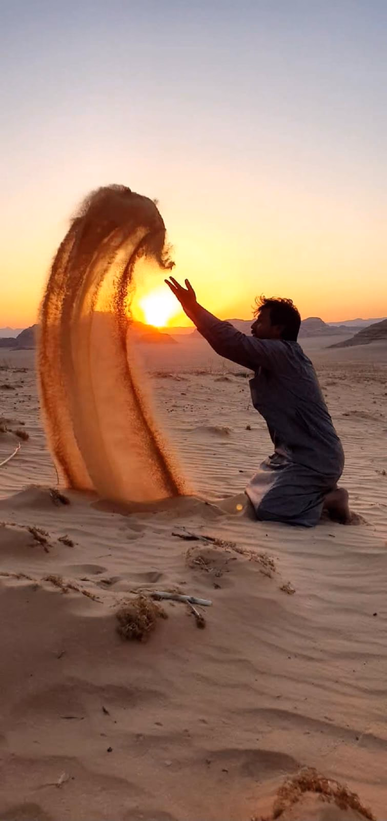 Throwing sand at sunset in Wadi Rum Desert, Wadi Rum