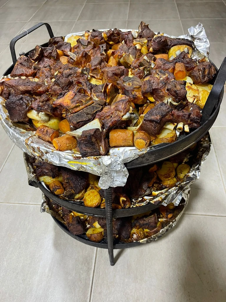 Meat cooking inside a traditional stacked desert oven