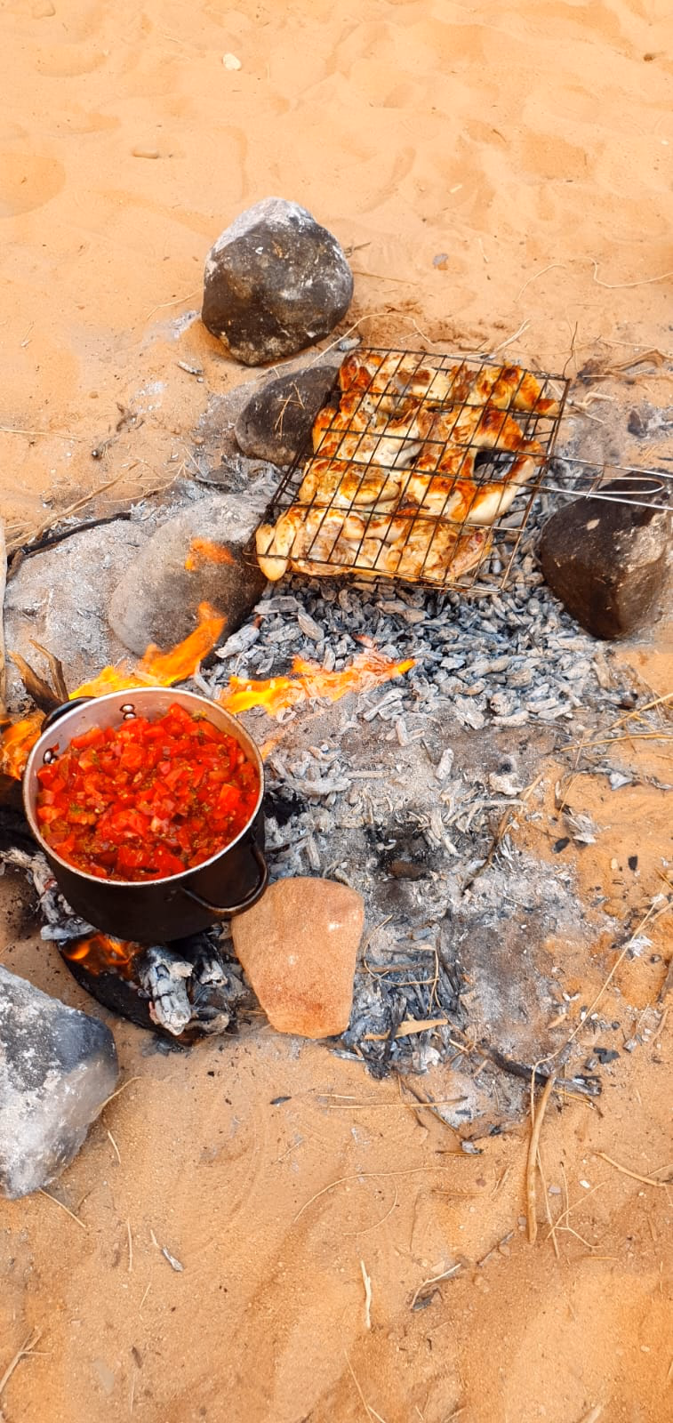 Chicken Desert BBQ with cooked tomatoes in Wadi Rum, Jordan
