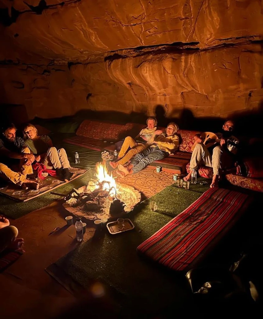 Guests sharing an evening meal beside the campfire