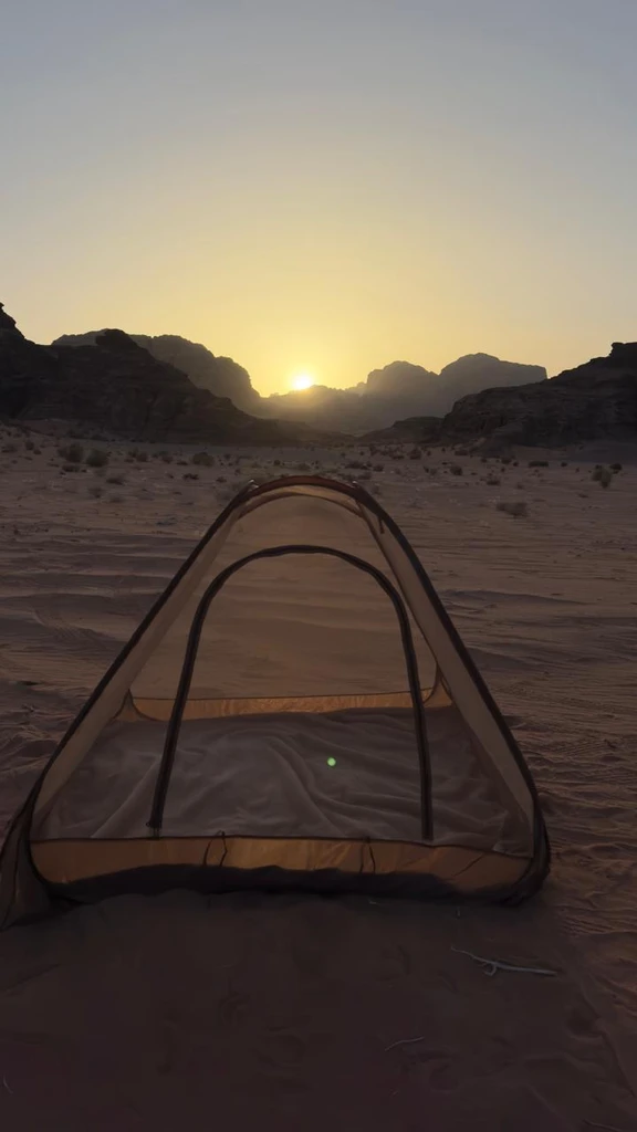 Tent in the desert at sunset