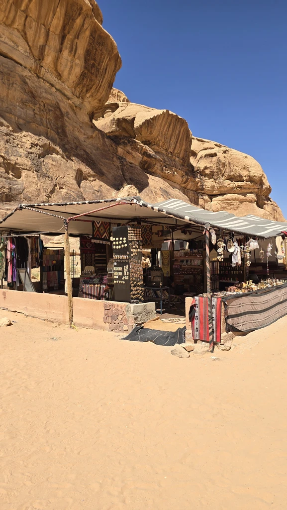 Bedouin market tent beneath sandstone cliffs in Wadi Rum