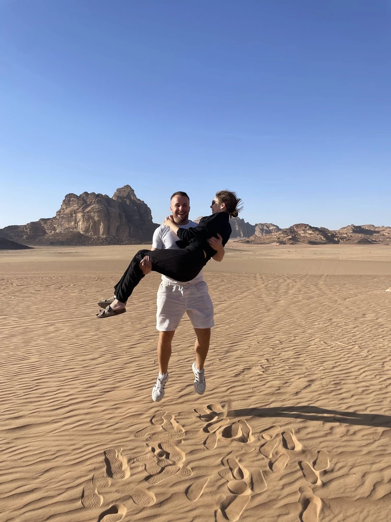Guest throwing sand into the air during a Wadi Rum desert tour