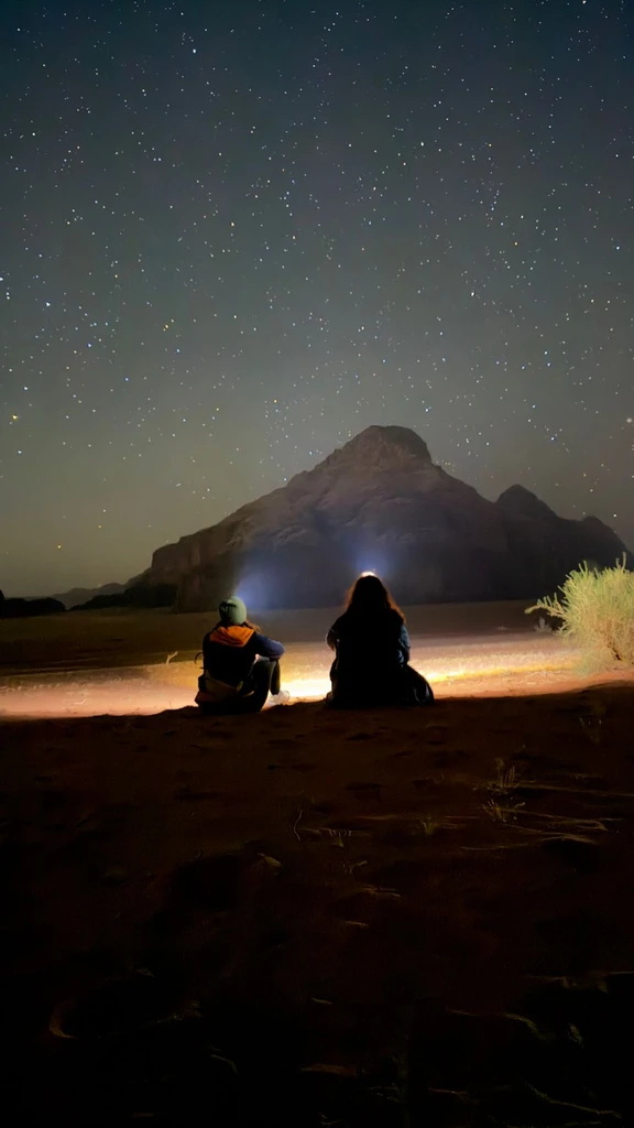 2 guests watching the stars during the night tour in Wadi Rum, Jordan