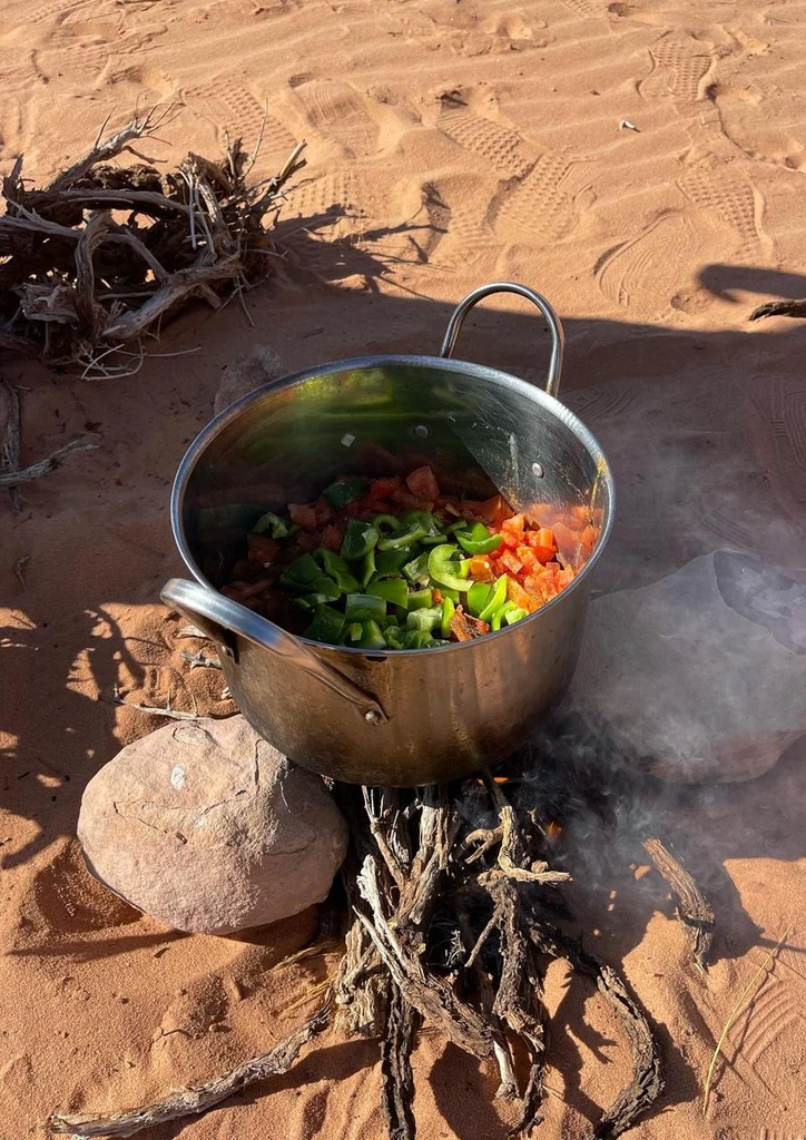 Pot of vegetables cooking in the desert