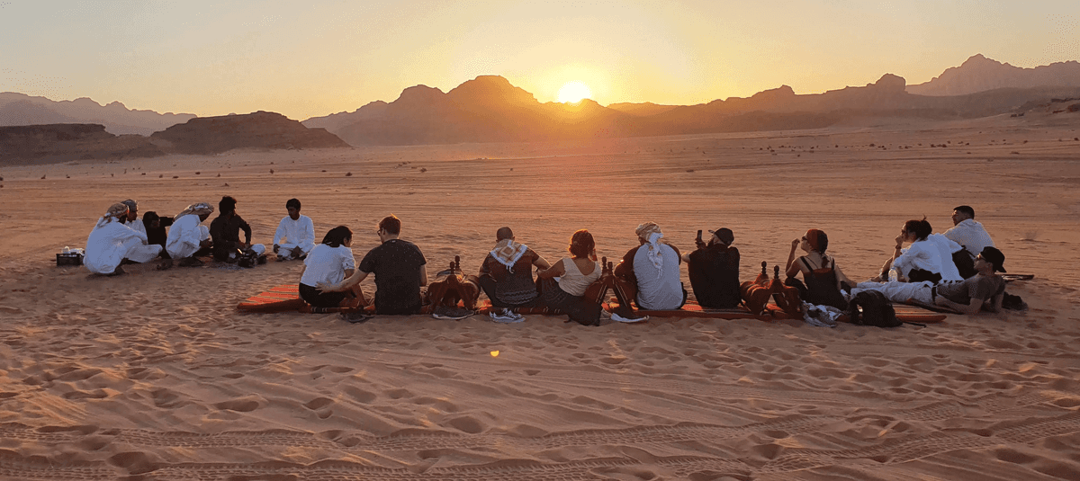 Guests watching sunset from desert cushions in Wadi Rum