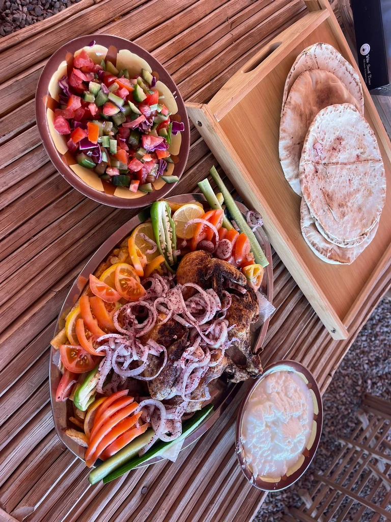 Fresh salads, bread and side dishes on a woven mat
