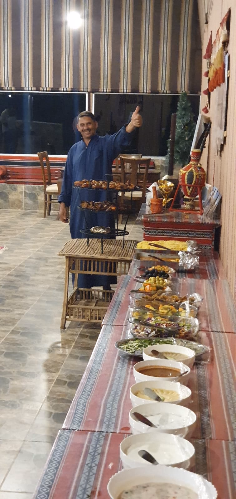 Meals in our Restaurant with our cook in the background Wadi Rum, Jordan