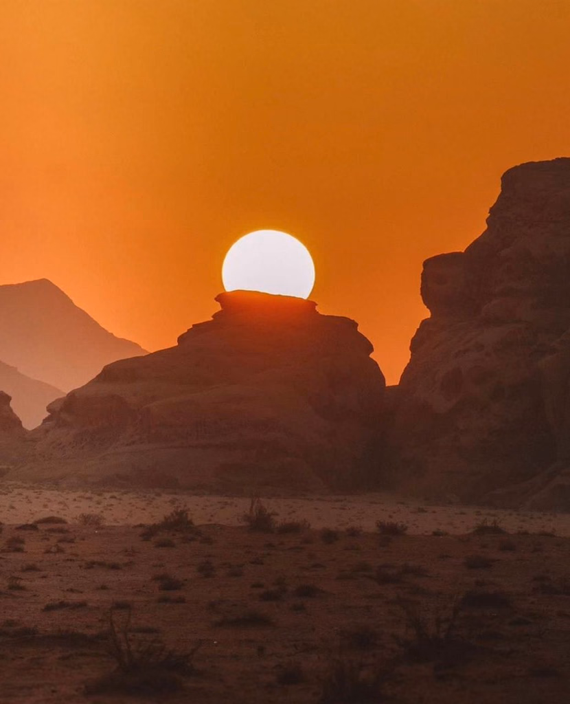Sun rising behind a rock wadi rum, jordan