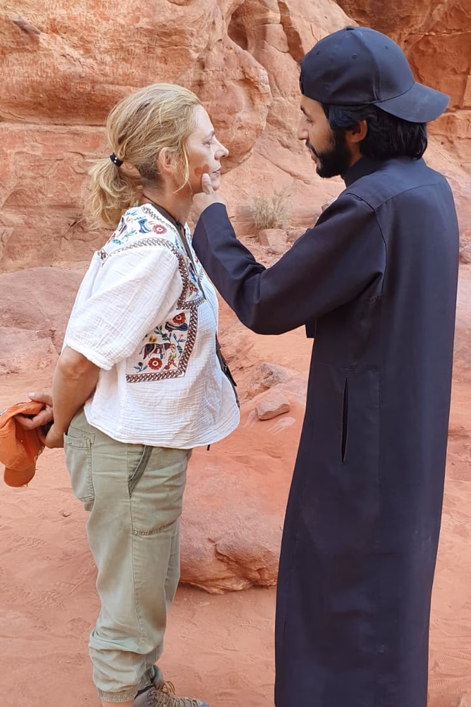 Local guide showing a guest details on a sandstone wall