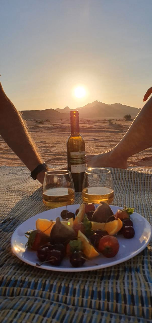Romantic sunset with wine at fruits