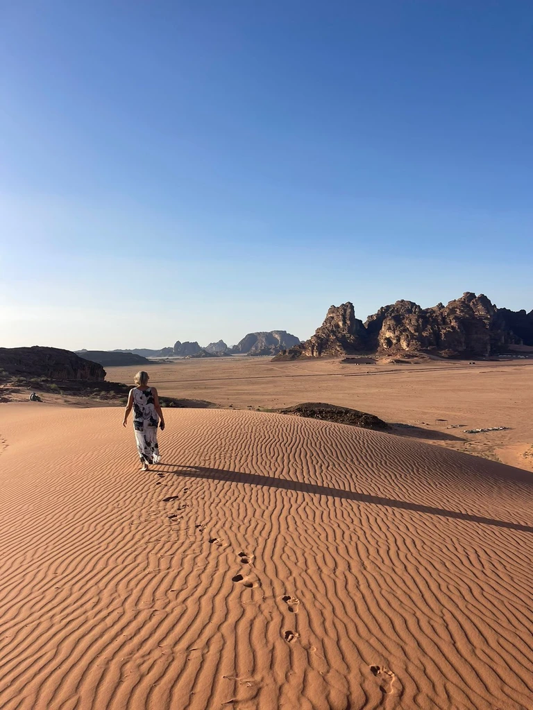Woman walking on sand in Wadi Rum desert, jordan